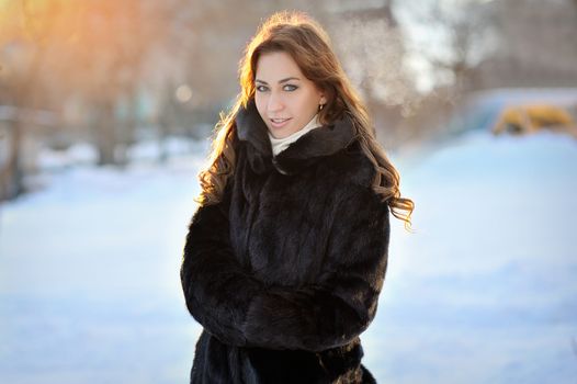 beautiful girl in brown winter coat on the street.