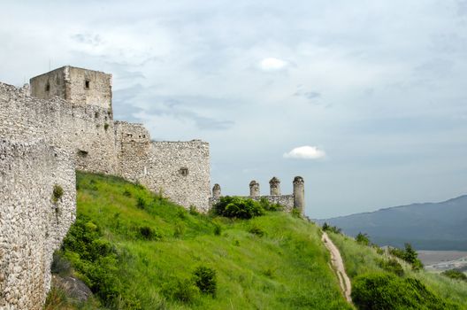 Stone castle's wall and towers on the hill. 