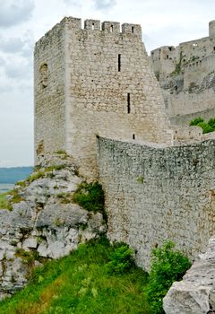 Stone castle tower at the top of rock.