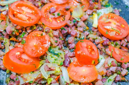 Tomatoes with bacon, onions and spices. Basis for a tomato sauce.