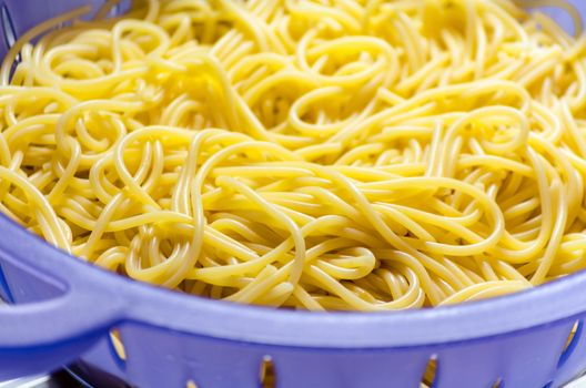 Noodles in a colander under cold water after the scare.