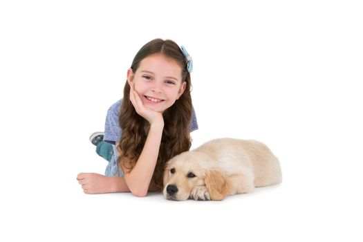 Lying little girl with a dog on white background 