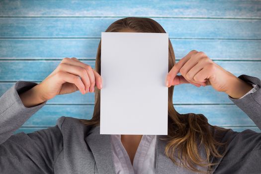 Businesswoman showing a card against wooden planks