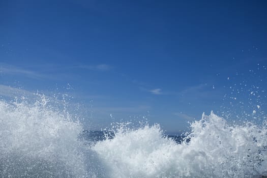 White wave against a blue sky