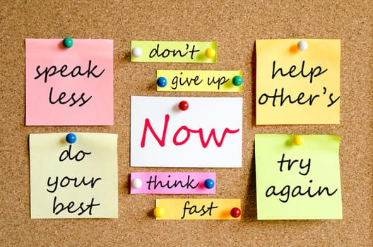 Colorful sticky notes on cork board background now concept