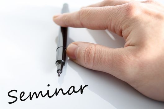 Pen in the hand isolated over white background seminar concept