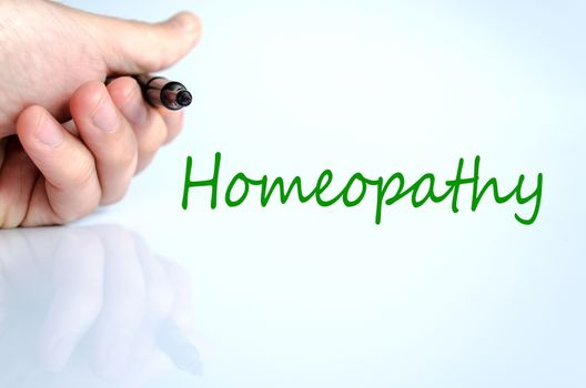 Pen in the hand isolated over white background homeopathy concept