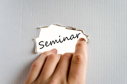 Hand on the cardboard background seminar concept
