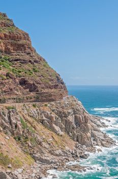 CAPE TOWN, SOUTH AFRICA - DECEMBER 12, 2014:  Chapmans Peak, a scenic drive between Noordhoek and Hout Bay. Nets to catch falling rocks are visible
