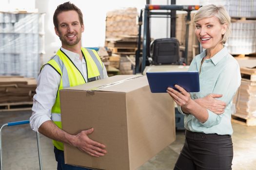 Warehouse manager and foreman working together in a large warehouse