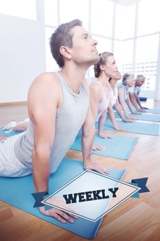 The word weekly and group doing cobra pose in row at yoga class against badge