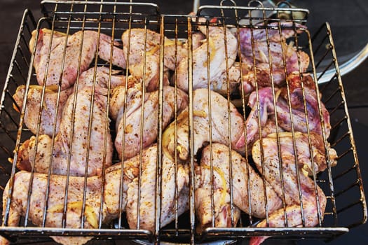 Raw chicken wings with spices on the barbecue                                