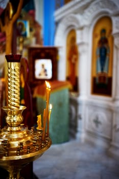 Candlestick with burning candles in a church 