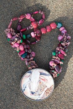 Beads from natural stones on asphalt. Top view