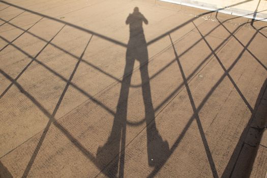 Shadow of a photographer with camera on roof.