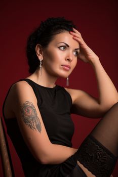 Studio portrait of a sexy brunette in black lingerie, stockings