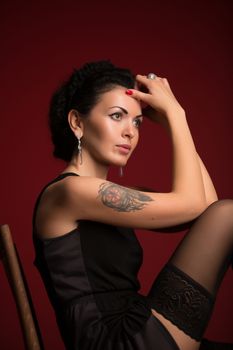 Studio portrait of a sexy brunette in black lingerie, stockings