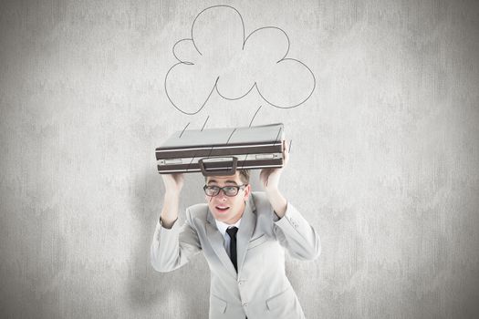 Geeky businessman holding his briefcase over head against white background