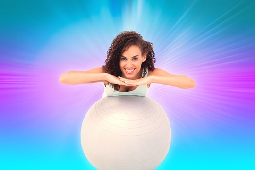 Fit woman with exercise ball against abstract background