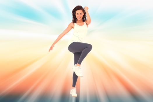 Fit woman doing aerobic exercise against abstract background