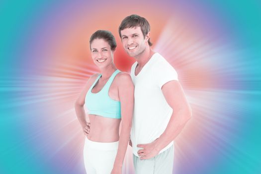 Fit couple smiling at camera against abstract background
