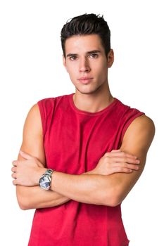 Serious looking young man wearing red t-shirt looking at camera isolated in white background