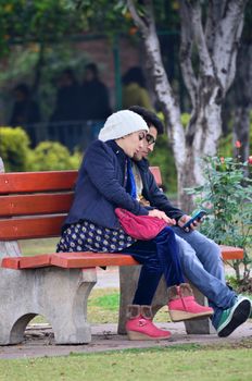 Chandigarh, India - January 4, 2015: Indian couple visit Zakir Hussain Rose Garden on January4, 2015 in Chandigarh, India. Zakir Hussain Rose Garden, is a botanical garden with 50,000 rose-bushes.