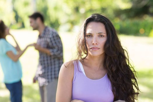 Woman upset at her crush with other girl on a sunny day