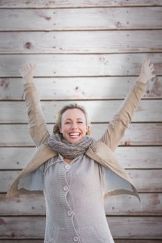 Cheering blonde against wooden planks