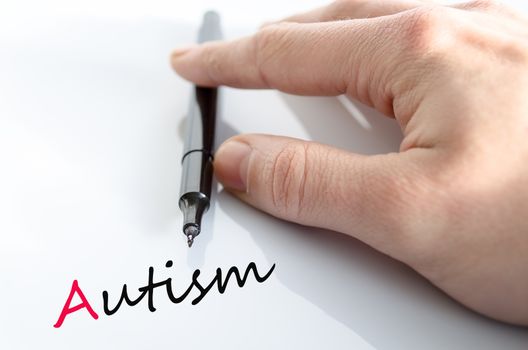 Pen in the hand isolated over white background autism concept