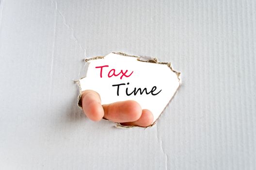Hand on the cardboard background tax time concept