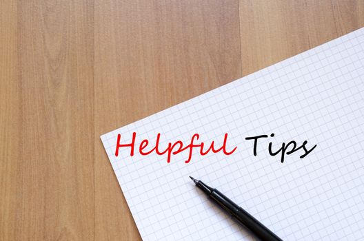 White blank notepad on office wooden table Helpful Tips concept