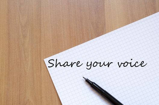 White blank notepad on office wooden table Share your voice concept