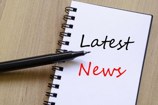 White notepad and ink pen on the wooden desk Latest news Concept