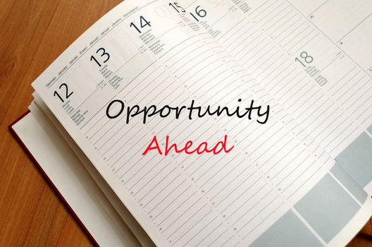 Business Notepad on wooden table Opportunity Ahead Concept