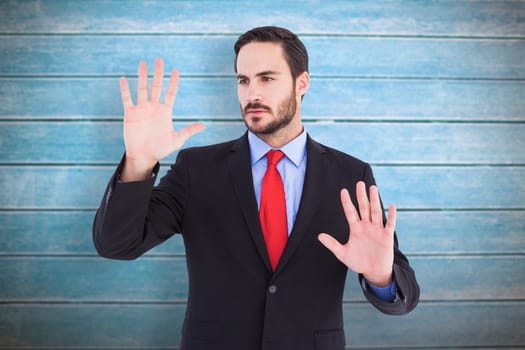 Businessman showing something with his hands against wooden planks