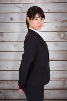 Serious businesswoman against wooden planks