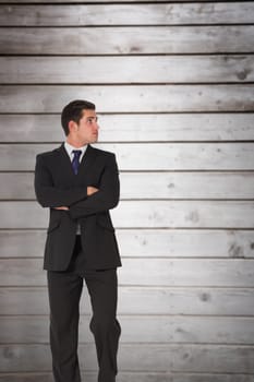 Businessman standing and looking against wooden planks