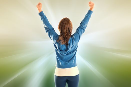 Cheering fit woman against abstract background