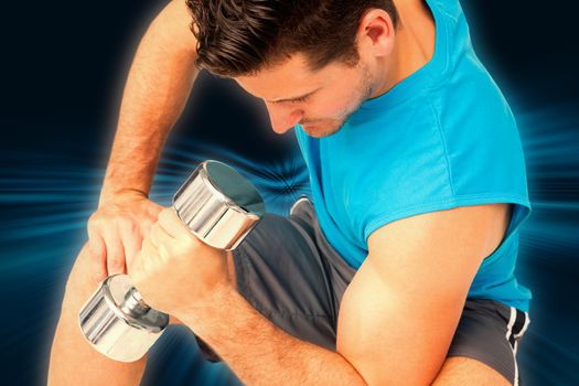 Close-up of a fit man exercising with dumbbell against abstract background