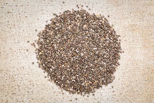 top view of chia seeds pile against rustic white painted barn wood