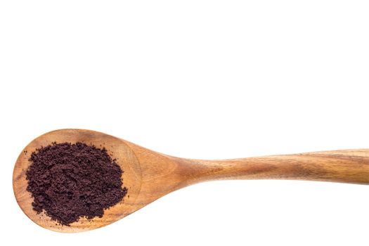 acai berry powder on a wooden spoon isolated on white with a clipping path