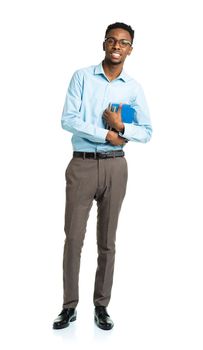 Happy african american college student with books in his hands standing on white background