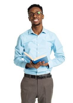 Happy african american college student with book in his hands standing on white background