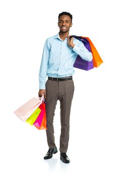 Happy african american man holding shopping bags on white background. Holidays concept