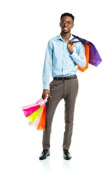 Happy african american man holding shopping bags on white background. Holidays concept