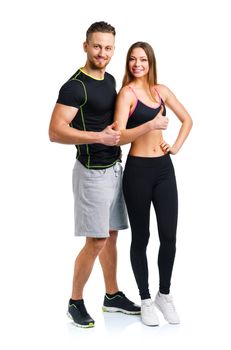 Athletic man and woman after fitness exercise with thumbs up on the white background