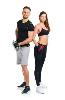 Sport couple - man and woman with dumbbells on the white background