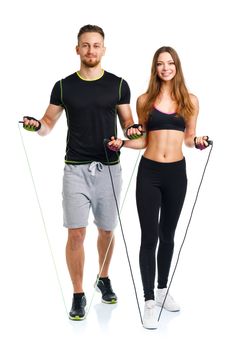 Happy athletic couple - man and woman with with ropes on the white background