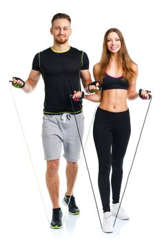 Happy athletic couple - man and woman with with ropes on the white background